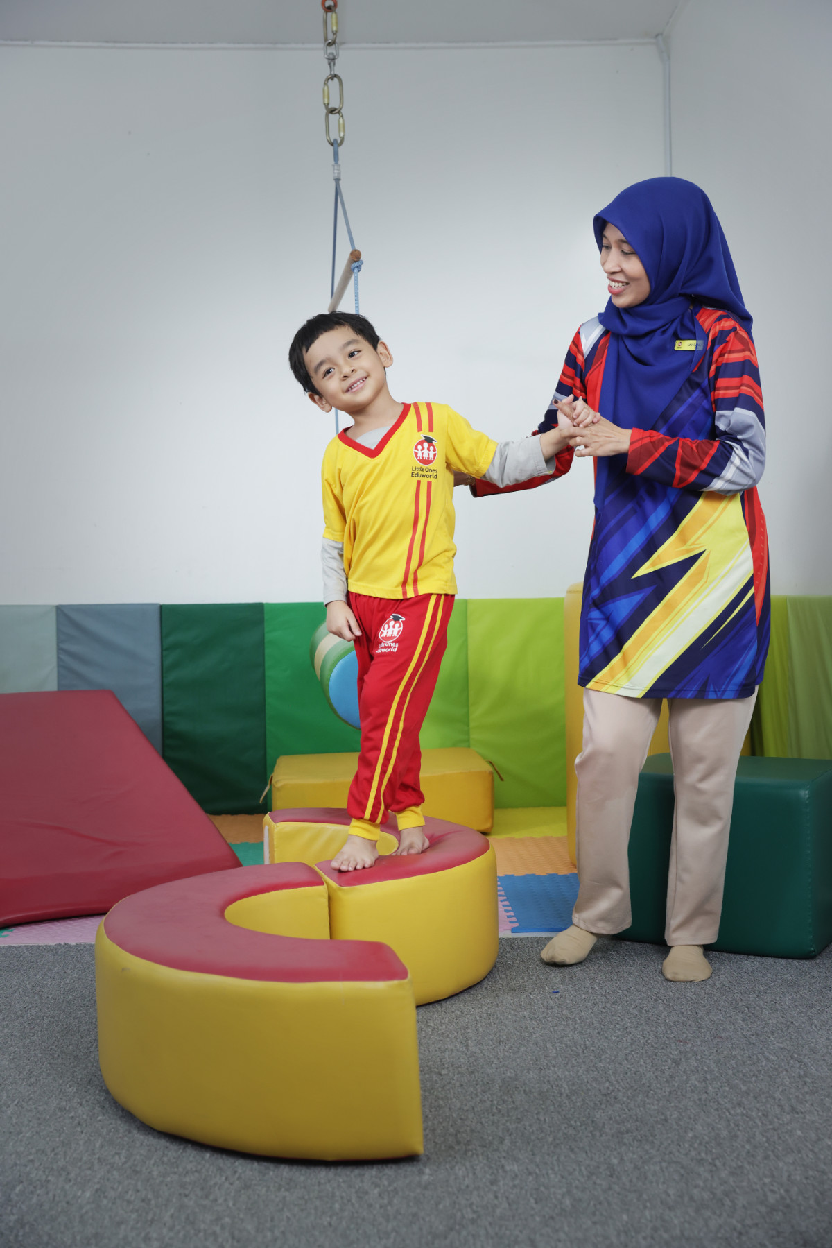 An educator supporting a child during occupational therapy